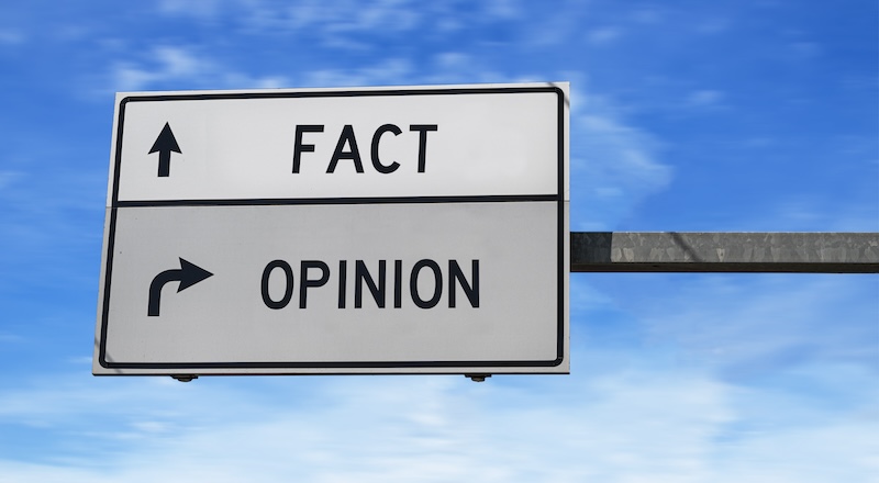 A road sign with "FACT" pointing in one direction and "OPINION" in another.