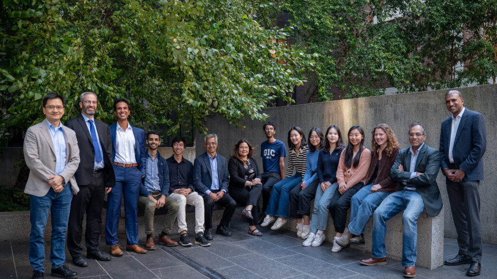 An image of the researchers standing and sitting in Quain Courtyard, in Penn Engineering